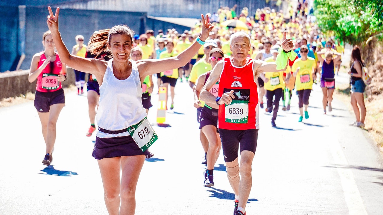 female and male runners in a marathon