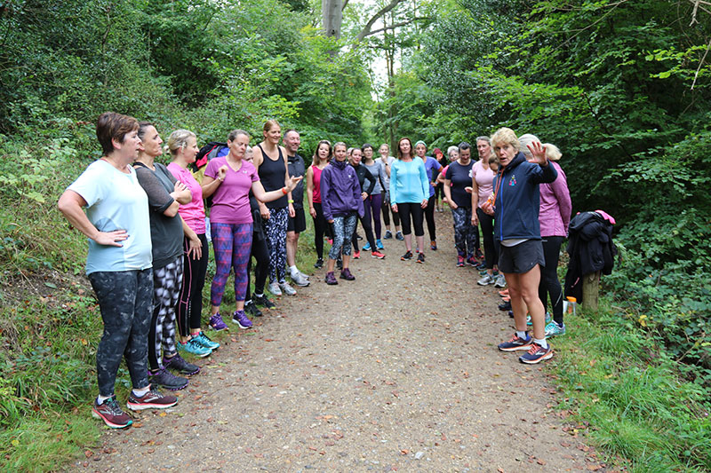 group of people receiving instructions from running coach